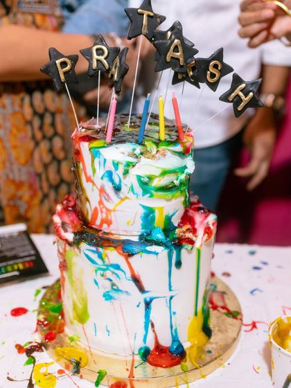 The final result of the kids' cake painting party. A wonderfully messy, vibrant, and unique cake that is full of happy memories.