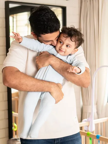 A big hug from dad. Capturing these moments of affection in your own home, near your baby's crib, makes the memory even more personal and special.