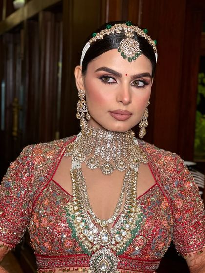 Radiating elegance and timeless beauty. This bride is a vision in red, with makeup that embodies the essence of a modern-day queen.