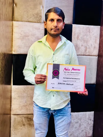 Another successful student, Rakesh, proudly holds his certificate of completion. We welcome students from all walks of life to join our professional beauty courses.