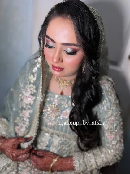 A close-up on the glittery eye makeup, which adds a touch of glam to the soft pastel look.