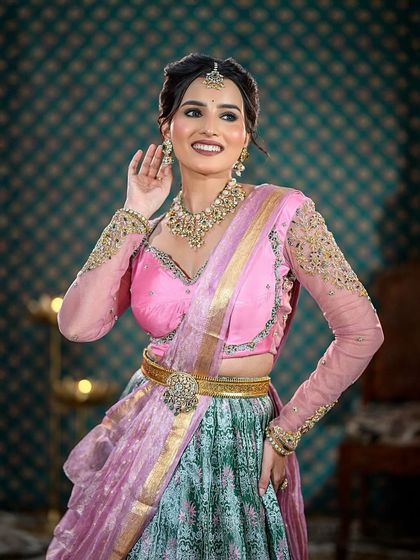 A happy, smiling portrait of the model in the half-saree, capturing a joyful moment.