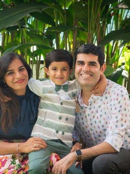 A picture-perfect family of three. This outdoor portrait captures their happy smiles and easy connection, a timeless keepsake of this stage in their lives.