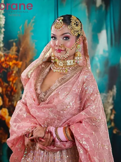 This portrait showcases the intricate Passa (side tikka) and the beautifully coordinated makeup.