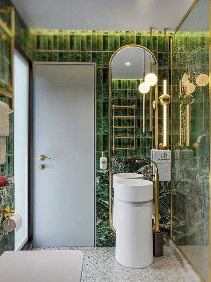 Another view of the green and gold master bathroom concept. This angle highlights the freestanding pedestal sinks and the rich texture of the green tiled wall.