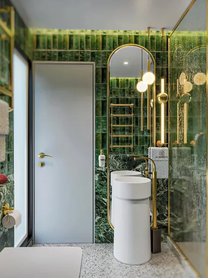 Another view of the green and gold master bathroom concept. This angle highlights the freestanding pedestal sinks and the rich texture of the green tiled wall.