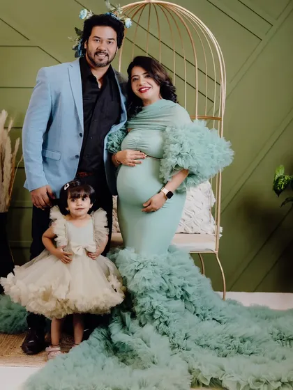 A beautiful family portrait taken at my studio. The mother's mint green gown coordinates wonderfully with her daughter's dress, showing how we can style the whole family.
