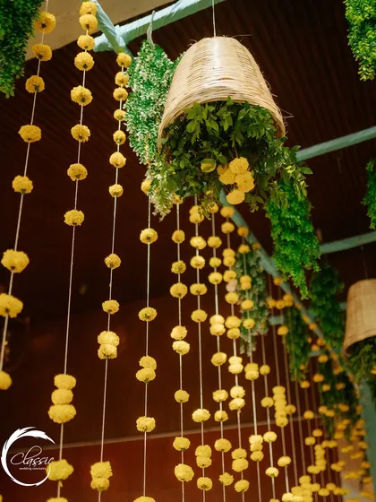 I love playing with height. Here, strings of marigolds and hanging wicker baskets filled with greenery create a beautiful overhead installation that adds texture and a rustic feel.