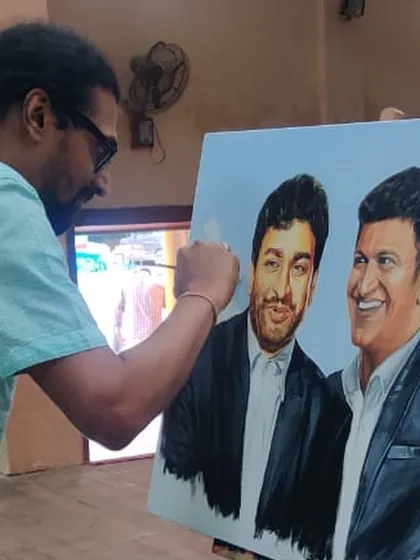 Here I am adding the final touches to the award winning portrait of Dr. Rajkumar and Puneeth Rajkumar. The process of creating a double portrait requires careful attention to the interaction and relationship between the two subjects.