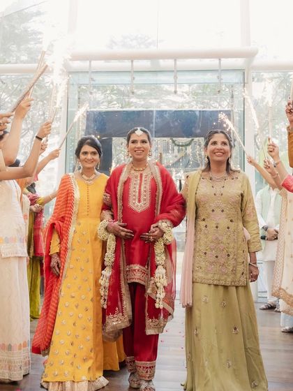 A sparkling entrance for the mom-to-be, guided by her own mother and mother-in-law. This is such a beautiful and symbolic moment in a Godh Bharai ceremony.