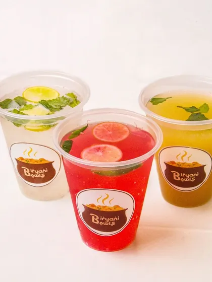 A trio of colorful summer coolers: kokum, masala lemonade, and aam panna. This shot effectively showcases the variety of drinks a restaurant offers.
