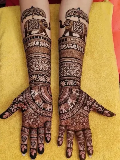 This majestic design features elephants carrying an umbrella (chhatri) on the forearms, a symbol of royalty. The palms are decorated with a full, circular mandala pattern, creating a balanced and grand look.