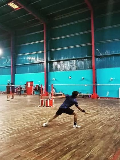 An action shot capturing a player lunging for a low shot, demonstrating the agility and flexibility we build through our dynamic training regimen.