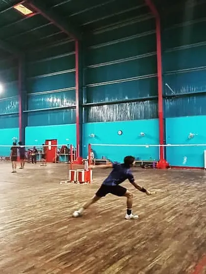 An action shot capturing a player lunging for a low shot, demonstrating the agility and flexibility we build through our dynamic training regimen.