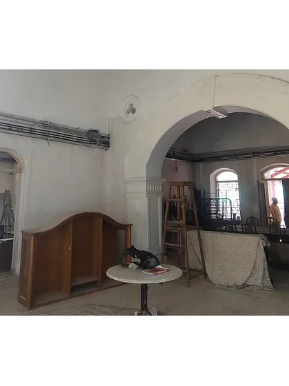 The main hall during construction, with its grand archway being prepared for plastering. This image captures the raw state of the interior, highlighting the structural forms that we work to enhance and preserve.