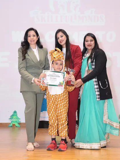 Another one of our talented performers in a leopard costume, being felicitated on stage during our Christmas event.