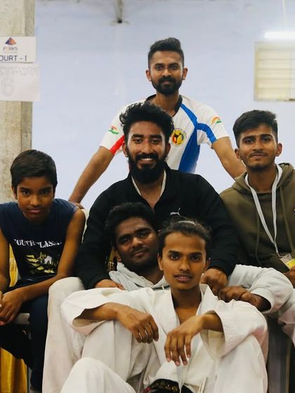 A candid moment with some of the competitors. The bonds we form at these tournaments are as valuable as the medals we win. This is the spirit of our karate family.