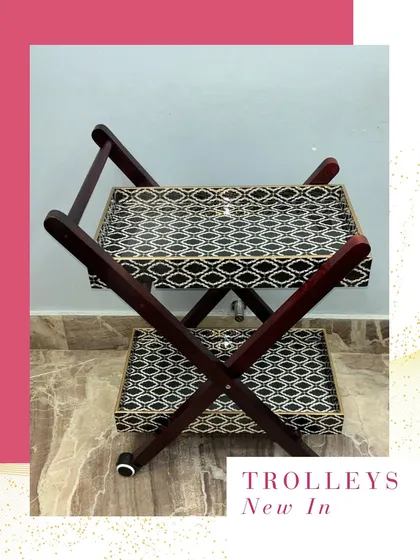 A new addition to my collection, this wooden two-tiered trolley with printed trays is perfect for serving guests in style. It's a functional and chic piece of home decor.