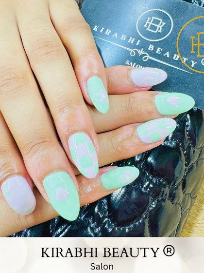 A playful mix-and-match pastel set. I combined a checkered pattern with a heart design using soft mint green and lilac polishes.