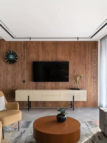 This living space is designed for a large family to gather. The earth-tone palette is enlivened by colorful furniture and decorative accessories.