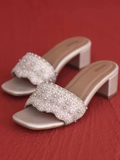 These block heels are detailed with delicate 3D flowers and pearls. They provide a comfortable lift, making them an ideal footwear choice for long hours of celebration during a mehendi or wedding.