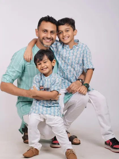 A fun and loving portrait of a father with his two sons in the studio. The coordinated outfits and happy expressions make this a wonderful memory of brotherhood and fatherhood.