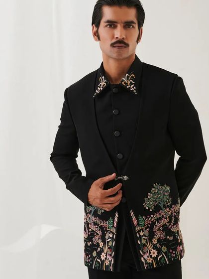 This pose highlights the intricate embroidery on the lower half of the Nazaakat bandhgala, inspired by the beauty of nature.