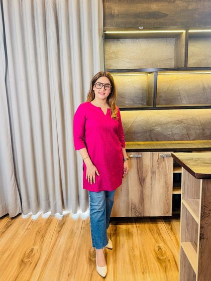 How to style your simple outfits? The hack is accessorizing. Here, a simple pink kurti and jeans are elevated with statement glasses and pointed heels.