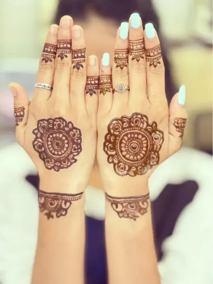 A perfect example of my modern minimalist style. This design pairs a delicate mandala on the back of the hand with a simple wristband and matching finger accents for a chic and elegant feel.