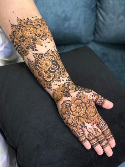 A full-arm floral design, with large, prominent flowers as the main feature.