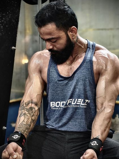 A moment of focus after a tough set. The wrist wraps and the sweat show the hard work that goes into every single workout.