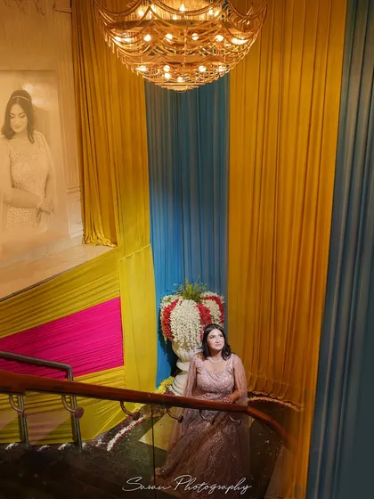 A wide shot of the bride on a grand staircase, with a double exposure effect showing her portrait.