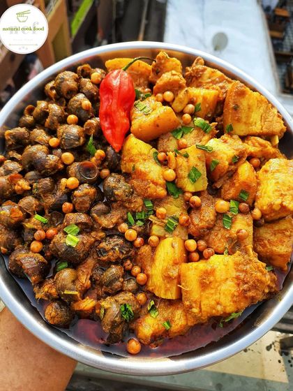 A unique and popular dish: pork and snails curry. The combination of tender pork and river snails creates a rich, earthy flavor that is a true Manipuri delicacy.