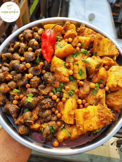 A unique and popular dish: pork and snails curry. The combination of tender pork and river snails creates a rich, earthy flavor that is a true Manipuri delicacy.