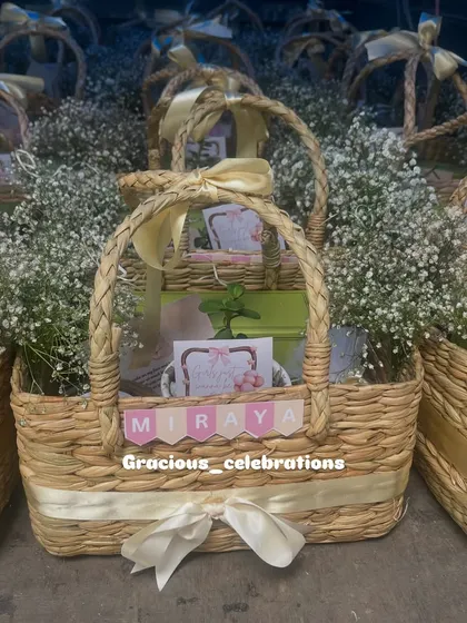 A closer look at the personalized first birthday baskets for Miraya. The custom name banner and coordinated ribbons make each gift feel unique.