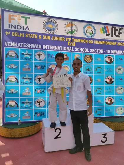 A coach and student celebrate a silver medal win at the 1st Delhi State Championship.