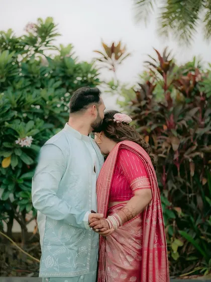 A sweet moment with the groom kissing the bride's forehead.