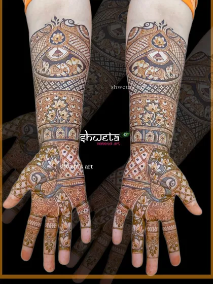 This design combines the best of traditional motifs. It features peacocks, elephants, and lotus flowers, all woven together in a dense, full-coverage pattern perfect for a bride.