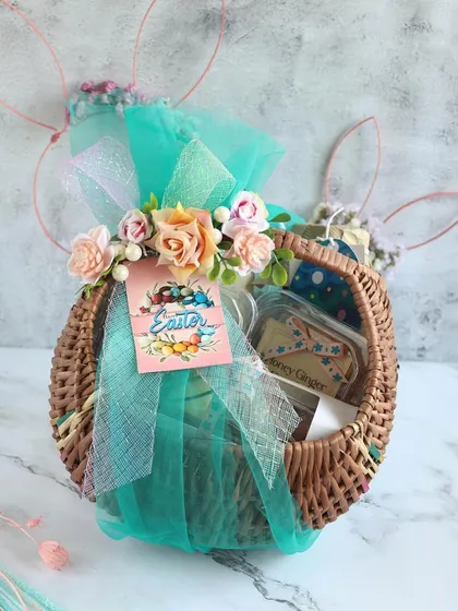 A rustic wicker Easter basket, beautifully wrapped and filled with our festive treats.