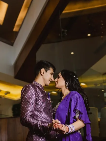 A low-angle shot looking up at the couple, about to share a kiss. This perspective adds a sense of grandeur and romance, with the ceiling architecture creating a beautiful frame.