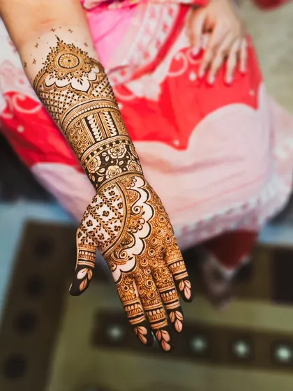 A full arm design that combines a variety of patterns, including florals, grids, and scalloped edges.