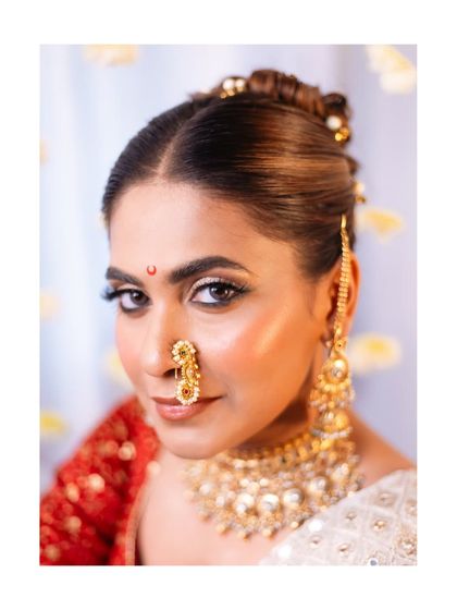 A close-up that captures the intensity and beauty of the makeup. The defined eyeliner, shimmering highlighter, and traditional bindi create a truly captivating look.
