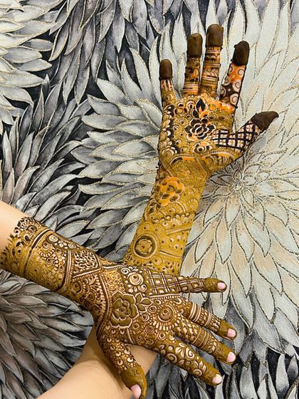 A creative pose showing off the beautiful details of this non-bridal mehendi.