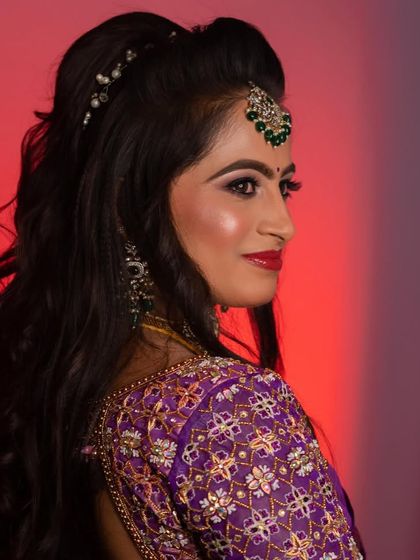 A beautiful shot capturing the detail of the hairstyle and the intricate embroidery on the blouse.