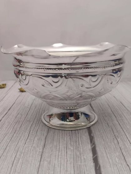 A German silver flower bowl with a scalloped edge. This versatile bowl can be used for flowers, prasad, or as a decorative piece.