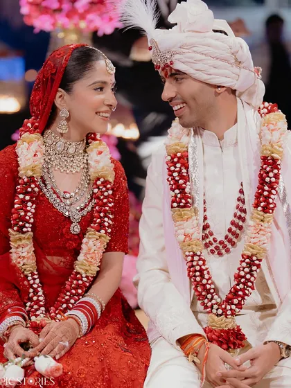 A quiet, shared smile between the bride and groom. In the midst of all the ceremonies and rituals, these are the moments of connection that truly matter. Parth and Jhanvi's easy chemistry is evident in this simple, beautiful shot.