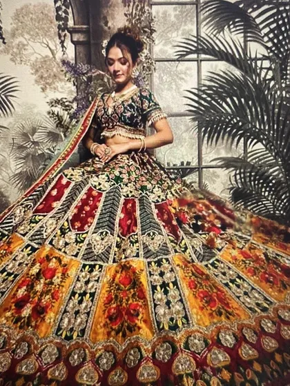 I love helping my clients stand out with unique pieces. This multi-colored panelled lehenga is perfectly complemented by a detailed choker and matching earrings, making it an ideal choice for a vibrant sangeet or mehendi function.