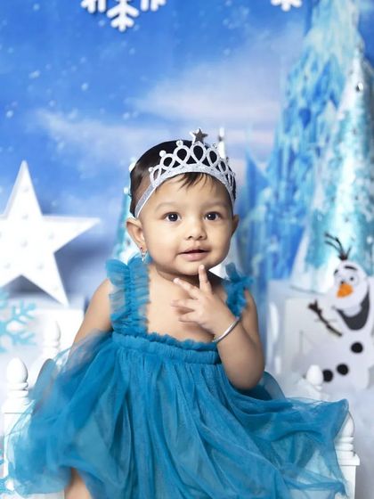 Another delightful shot from the Frozen session, capturing a curious and playful expression. The detailed backdrop and props create an immersive and enchanting scene for your baby's portrait.