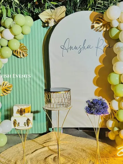 A fresh and elegant birthday setup with sage green and white balloons, perfect for an outdoor party.