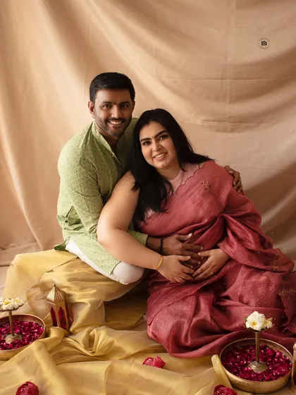 A happy and intimate portrait from a traditional maternity photoshoot. The warm colors and genuine smiles make this a cherished memory.